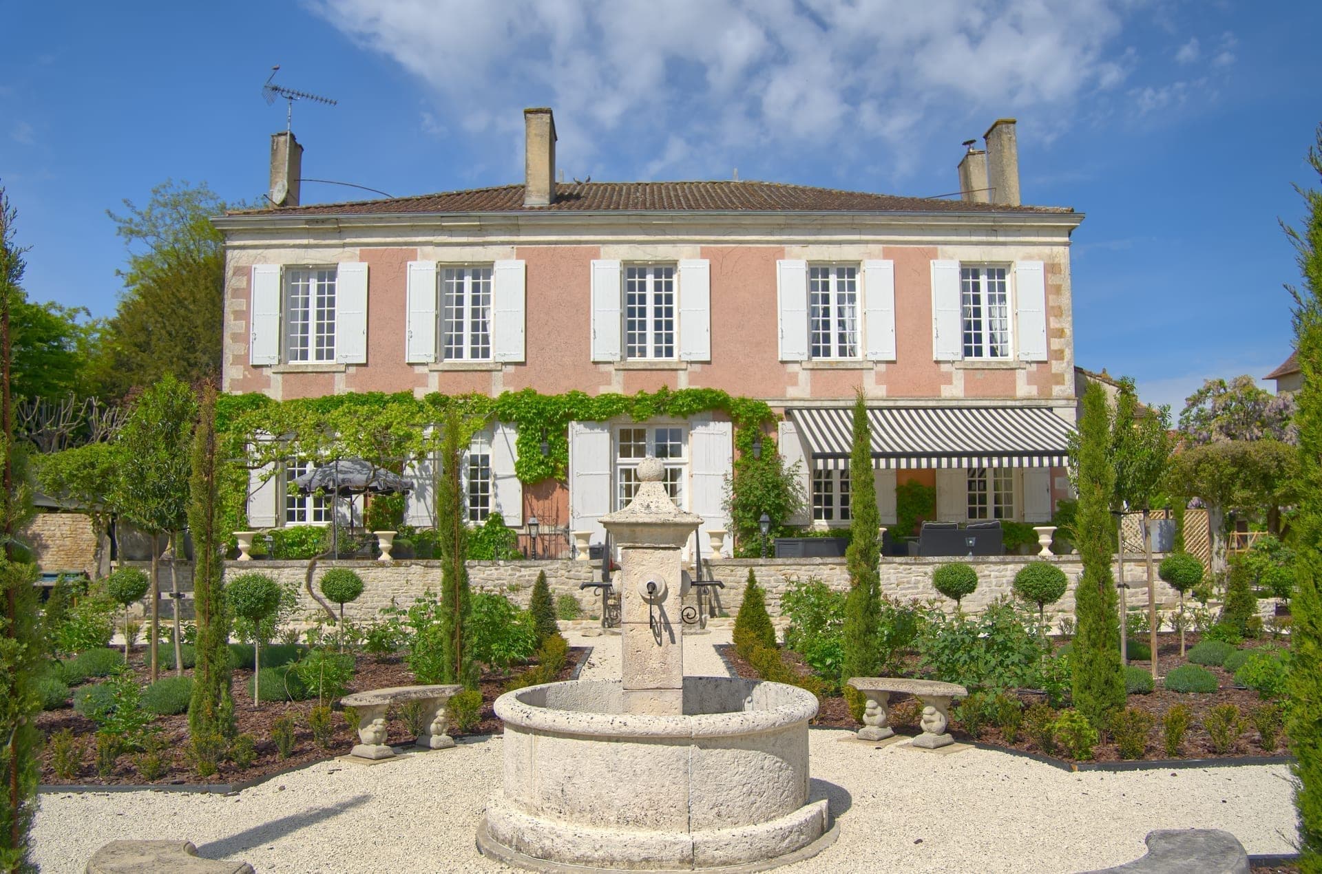 Château Lesvescault — the rear of the main house with its historic stone facade and gardens