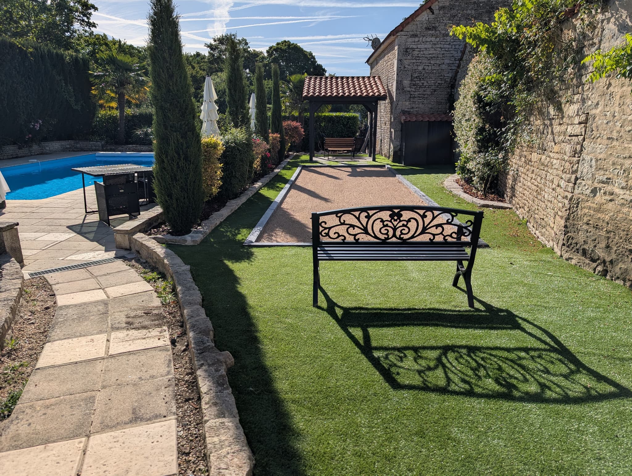 Château Lesvescault — pétanque court beside the pool terrace