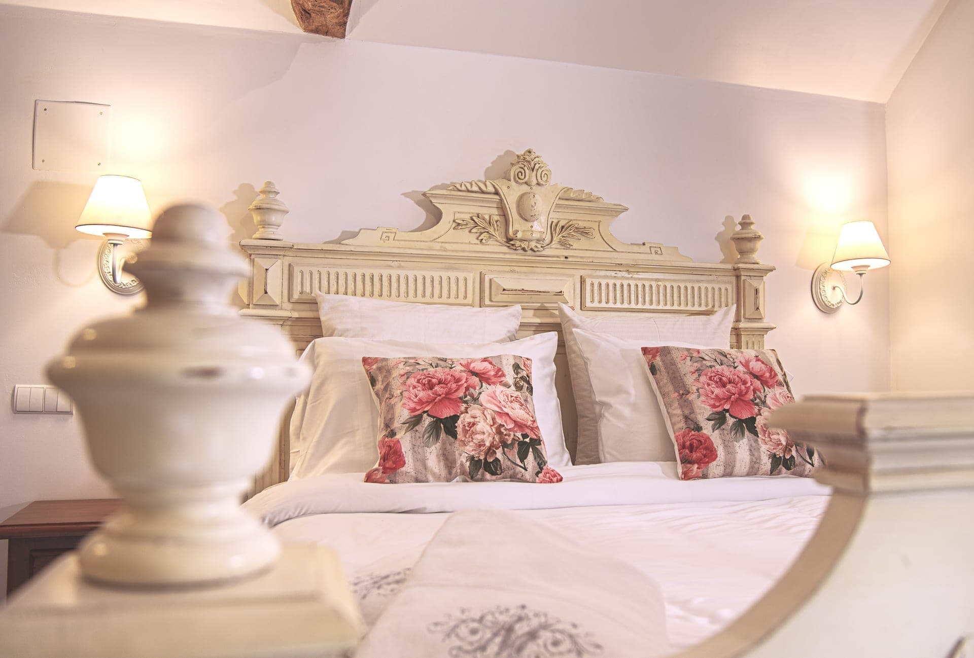 L'orangerie main bedroom with antique French headboard
