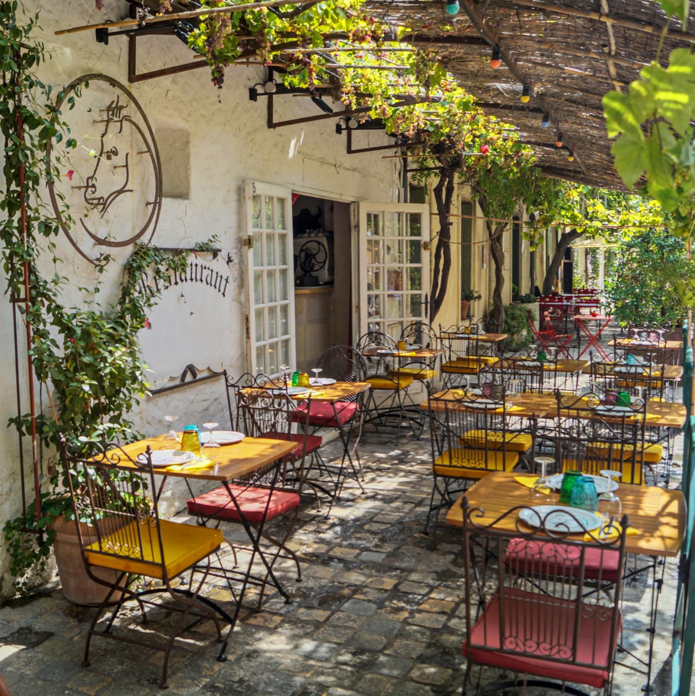 A sun-dappled terrace of a French village restaurant, Charente